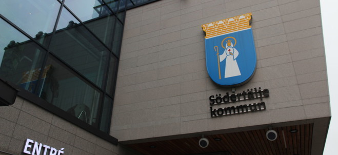 Södertälje stadshus exteriört, med kommunens logotyp på fasaden.
